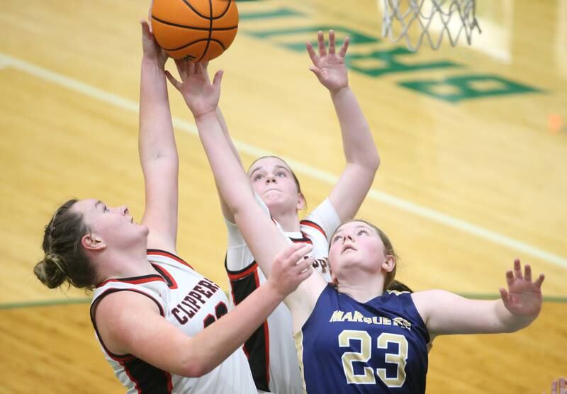 Amboy/Ohio's Emily Sachs with the help of teammate Addison Pertell grab a rebound over Marquette's Kelsey Cuchra during the Class 1A Regional championship on Thursday, Feb. 20, 2025 at St. Bede Academy.