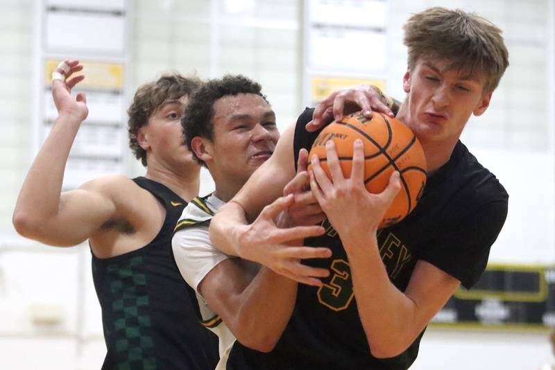 Crystal Lake South’s Cooper Buelna, center, tussles with Waubonsie Valley’s Cade Valek, right, for the ball during Hinkle Holiday Classic varsity boys basketball tournament title game action on Friday, Dec. 27, 2024 at Jacobs High School in Algonquin.