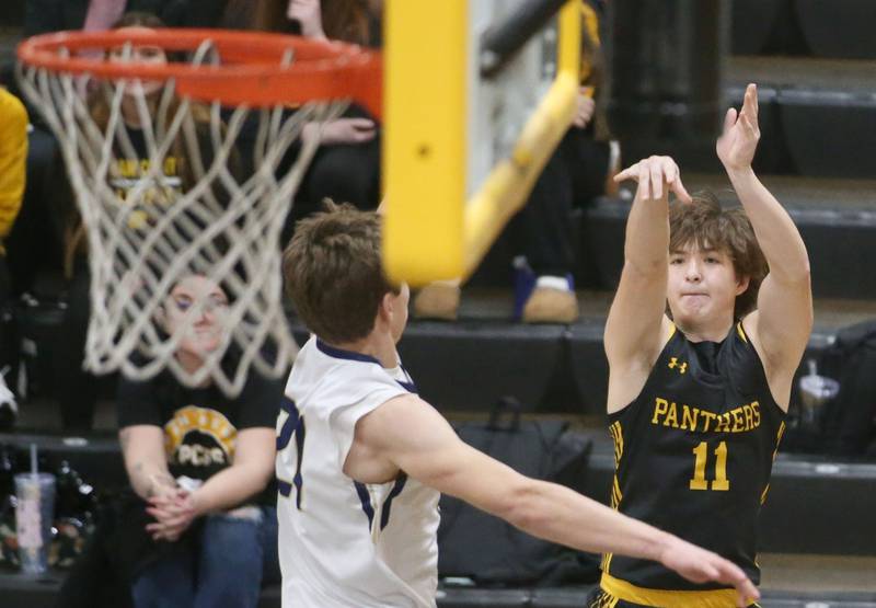 Putnam County's Owen Saepharn shoots a jump shot over Marquette's Charlie Mullen during the Tri-County Conference Tournament on Tuesday, Jan. 23, 2024 at Putnam County High School.