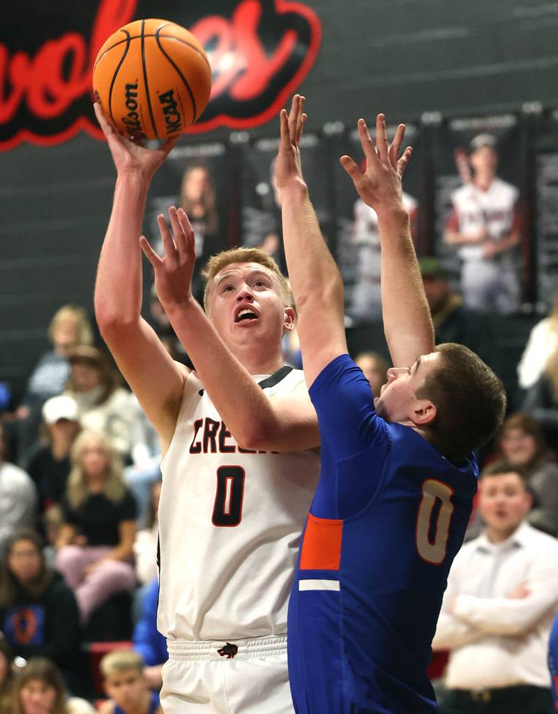 Indian Creek's Everett Willis shoots over Genoa-Kingston's Nathan Kleba during their game Friday, Jan. 3, 2025, at Indian Creek High School in Shabbona.