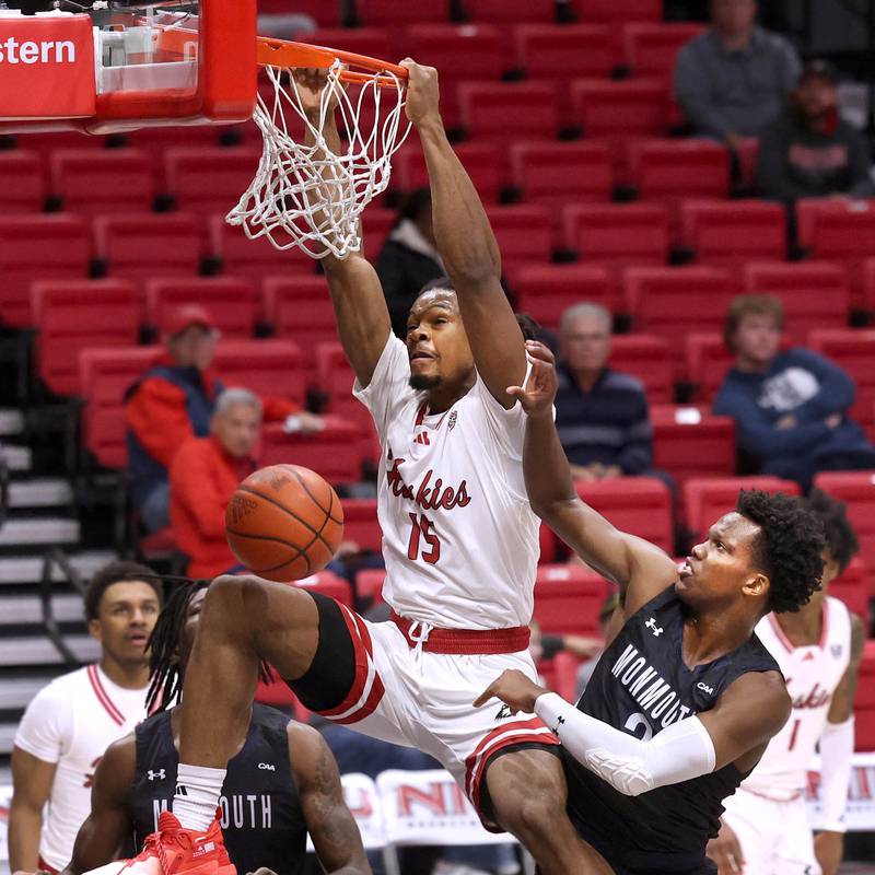 Northern Illinois' Ethan Butler gets a dunk off a rebound in front of Monmouth's Madison Durr during their game Tuesday, Nov. 12, 2024, in the Convocation Center at NIU in DeKalb.