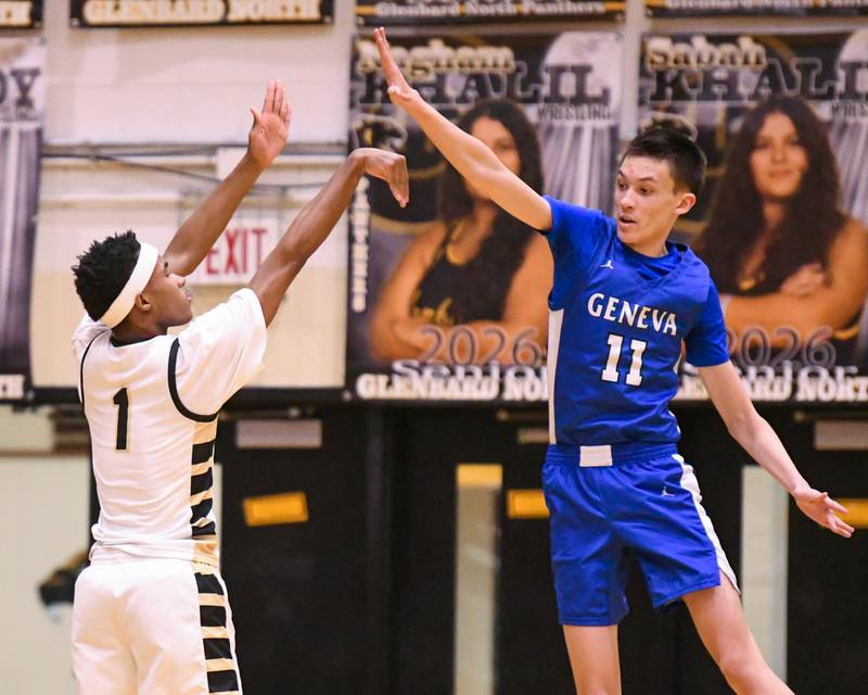 Glenbard North's Lamari Carpenter (1) makes a basket while being defended by Geneva's Kyle Suger (11) during the game on Tuesday Jan. 6, 2025, held at Glenbard North High School.