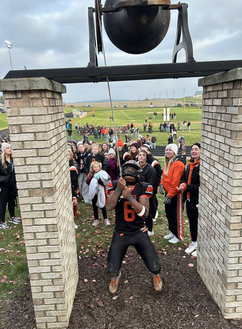 Milledgeville senior Micah Toms-Smith (6) rings the "victory" bell after the Missles' 28-14 win over Polo during 8-man playoff action on Saturday, Nov. 16, 2024 at Milledgeville. The Missiles ring the bell after every victory, including road wins.