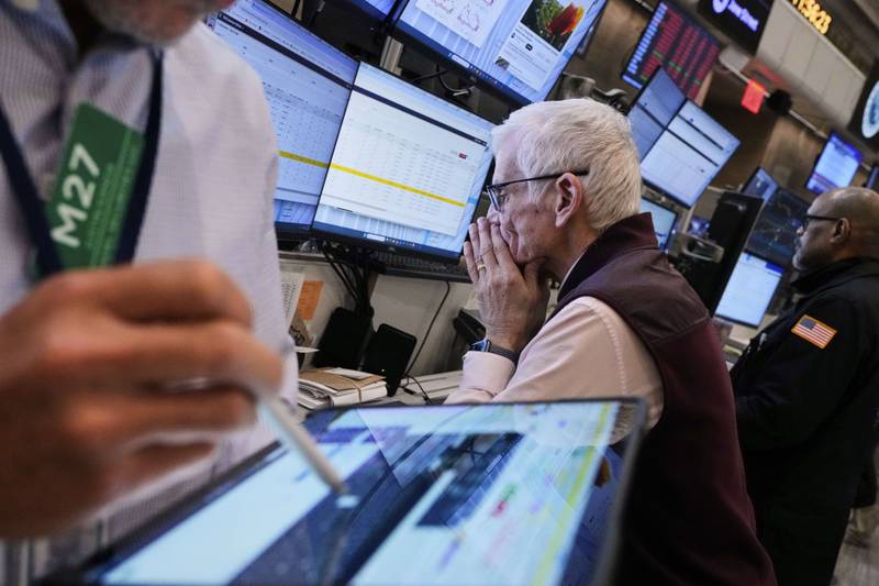 Trader Peter Herits, center, works on the options floor of the New York Stock Exchange, Thursday, April 10, 2025. (AP Photo/Richard Drew)