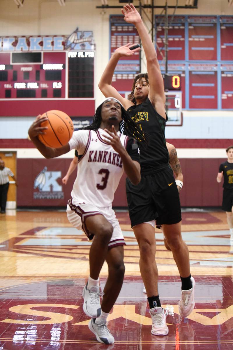 Kankakee's Cedric Terrell III, left, goes for a layup as Waubonsie Valley's Kristopher Mporokoso defends during a game at Kankakee Monday, Feb. 16, 2026.