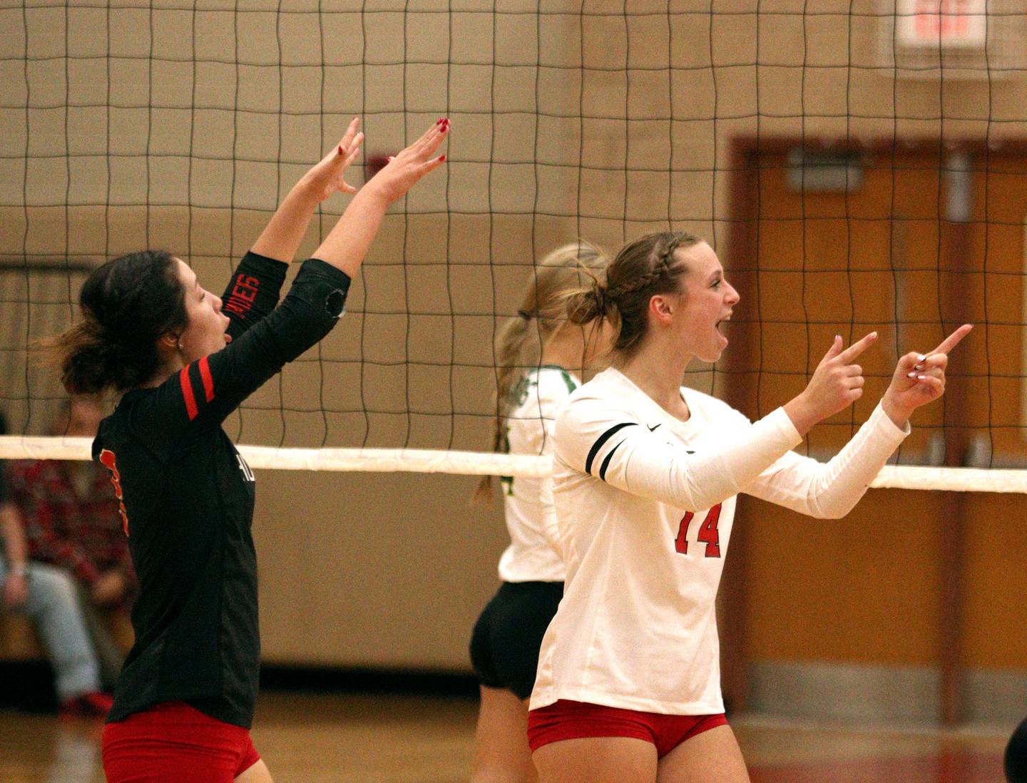 Huntley’s Sienna Robertson, right, and Amaralyse Rodriguez, left, celebrate during the Red Raiders’ two-set win over Crystal Lake South in varsity volleyball at Huntley Tuesday.