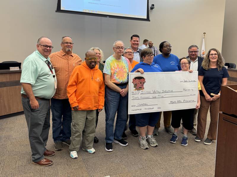 Representatives from the Morris BBQ Association and Morris Mayor Chris Brown present Illinois Valley Industries with a $20,000 check.