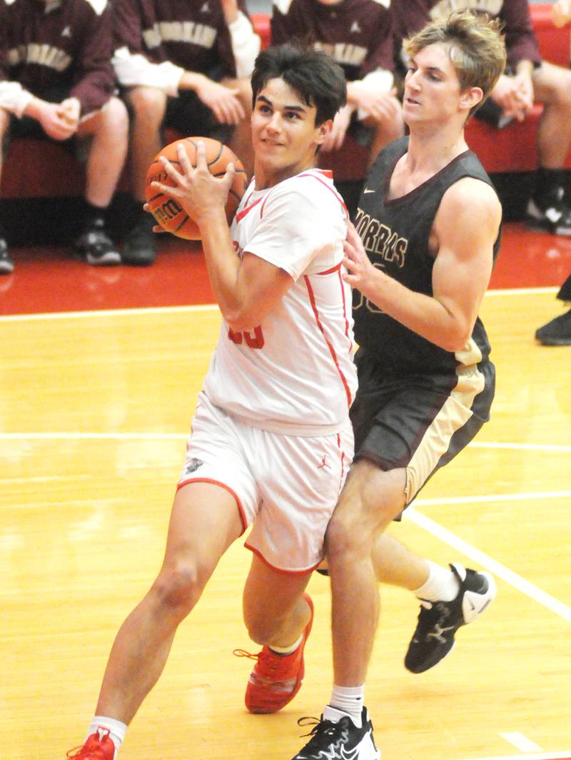 Ottawa's Payton Knoll drives past Morris' Jonah Williams in Kingman Gym on Friday, Dec. 2, 2022 in Ottawa.