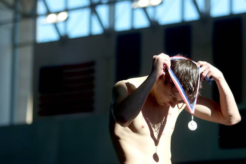 Drew Watson of Cary-Grove co-op accepts his medal after winning the 200-yard individual medley at the Fox Valley Conference Boys Swimming Invite at Woodstock North on Saturday.
