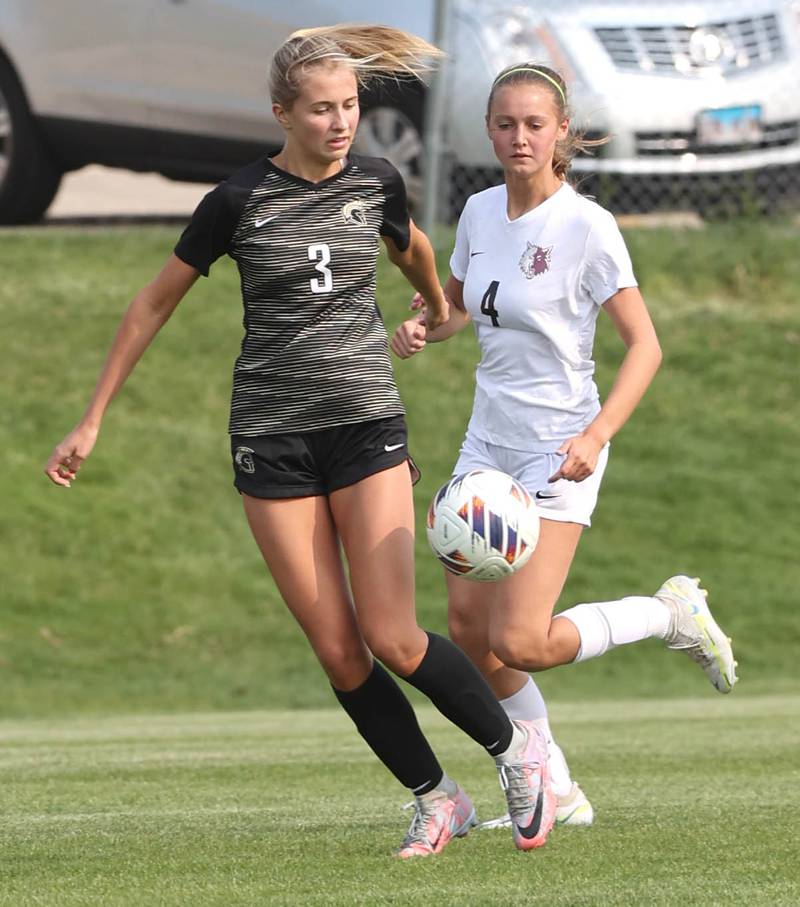 Sycamore's Jetta Weaver (left) and Prairie Ridge's Emily Gorton chase down a loose ball during their game Wednesday, May 17, 2023, at Sycamore High School.
