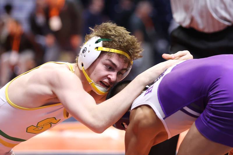 Crystal Lake South’s Josh Glover grabs Rochelle’s Xavier Villalobos in the Class 2A 113lb. semifinals at State Farm Center in Champaign. Friday, Feb. 18, 2022, in Champaign.