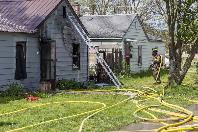 Firefighters work at the scene of a house fire at 204 East 11th Street in Rock Falls Wednesday, May 1, 2024.