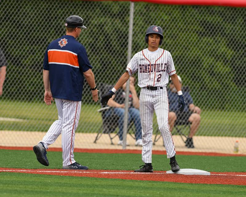 Romeoville's Justin Perez (2) gets congratulated by his coach as he get a triple during the regional game while taking on Yorkville on Thursday May 29, 2025, held at Yorkville High School.
