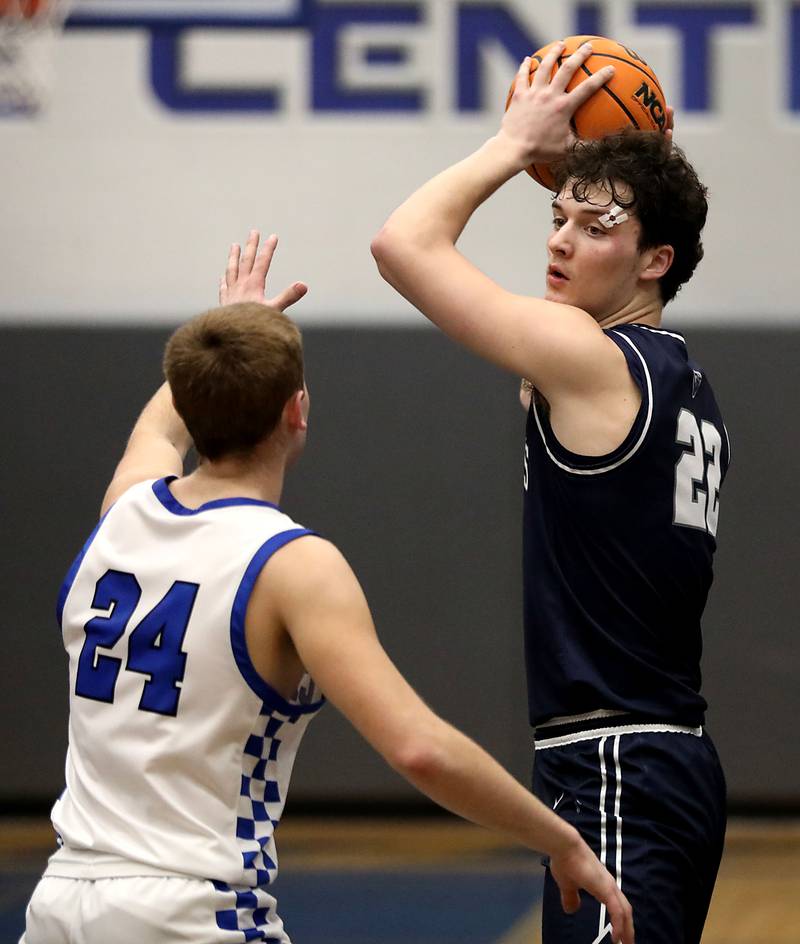 Cary-Grove's Adam Bauer looks to pass the ball as he is guarded by Burlington Central's Bennek Braden during a Fox Valley Conference boys basketball game on Friday, February. 6, 2026, at Burlington Central High School.