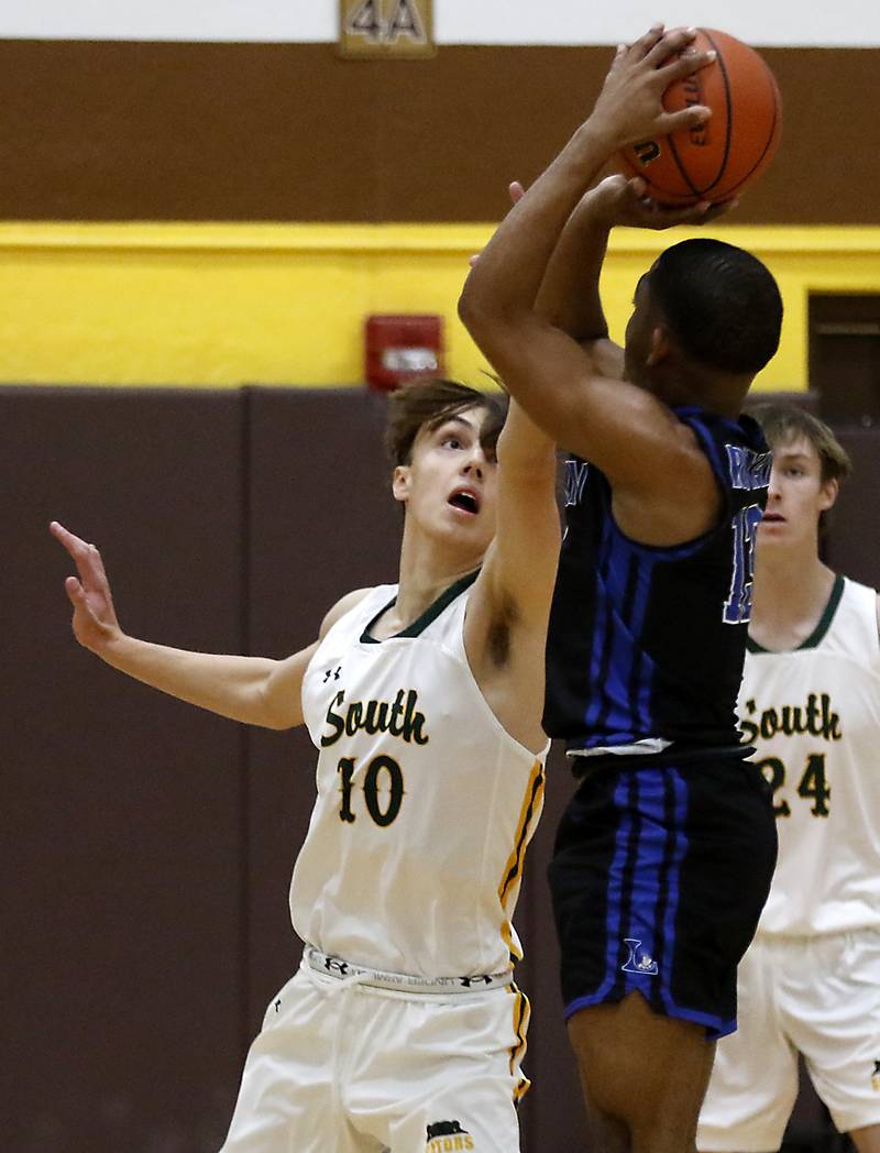 Crystal Lake South's Cam Miller trie to block the shot of Larkin’s Darnell Wilder during a Hinkle Holiday Classic basketball game Wednesday, Dec. 28, 2022, at Jacobs High School in Algonquin.