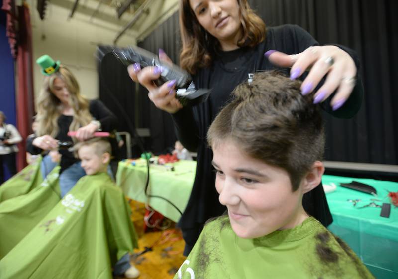 Forest Road 6th grader Brooks Pelletier is among the many students who shaved their heads by D'Amici hair stylists including Elisa Zolna during the St. Baldrick fundraiser held Thursday, March 7, 2024.