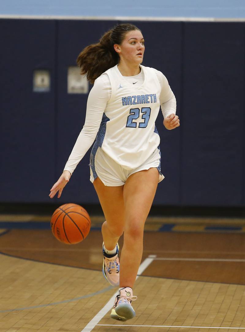 Nazareth's Danielle Scully (23) handles the ball during the girls varsity basketball game between Carmel High School and Nazareth Academy on Wednesday, Dec. 7, 2022 in LaGrange, IL.