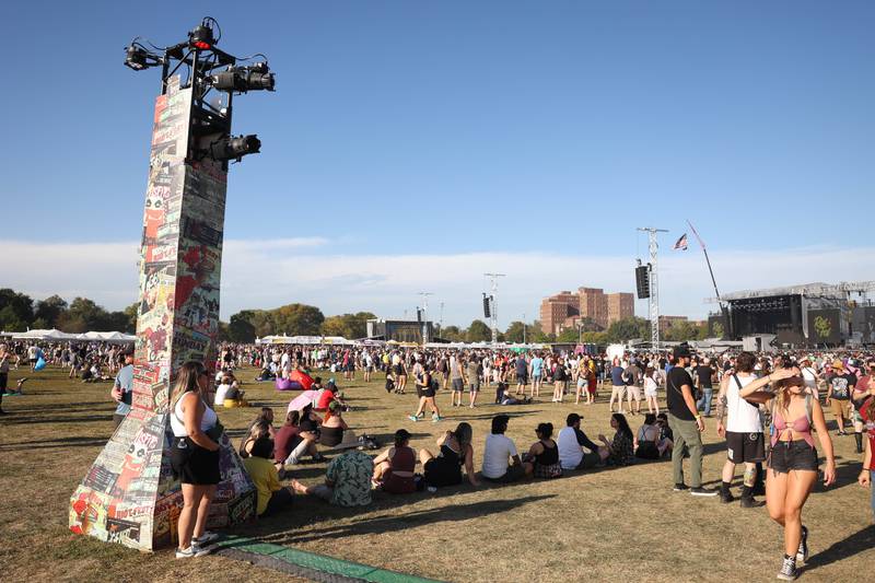 People creatively find shade behind a pillar as temperatures reached the low 90's at Riot Fest on Saturday, Sept. 21, 2024 in Chicago.