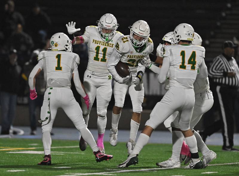Providence Catholic's Anthony Iaquinta (21) celebrates with teammates after recovering the ball on a muffed kickoff during the conference game against Joliet Catholic on Friday, OCT. 24, 2025, at Joliet.
