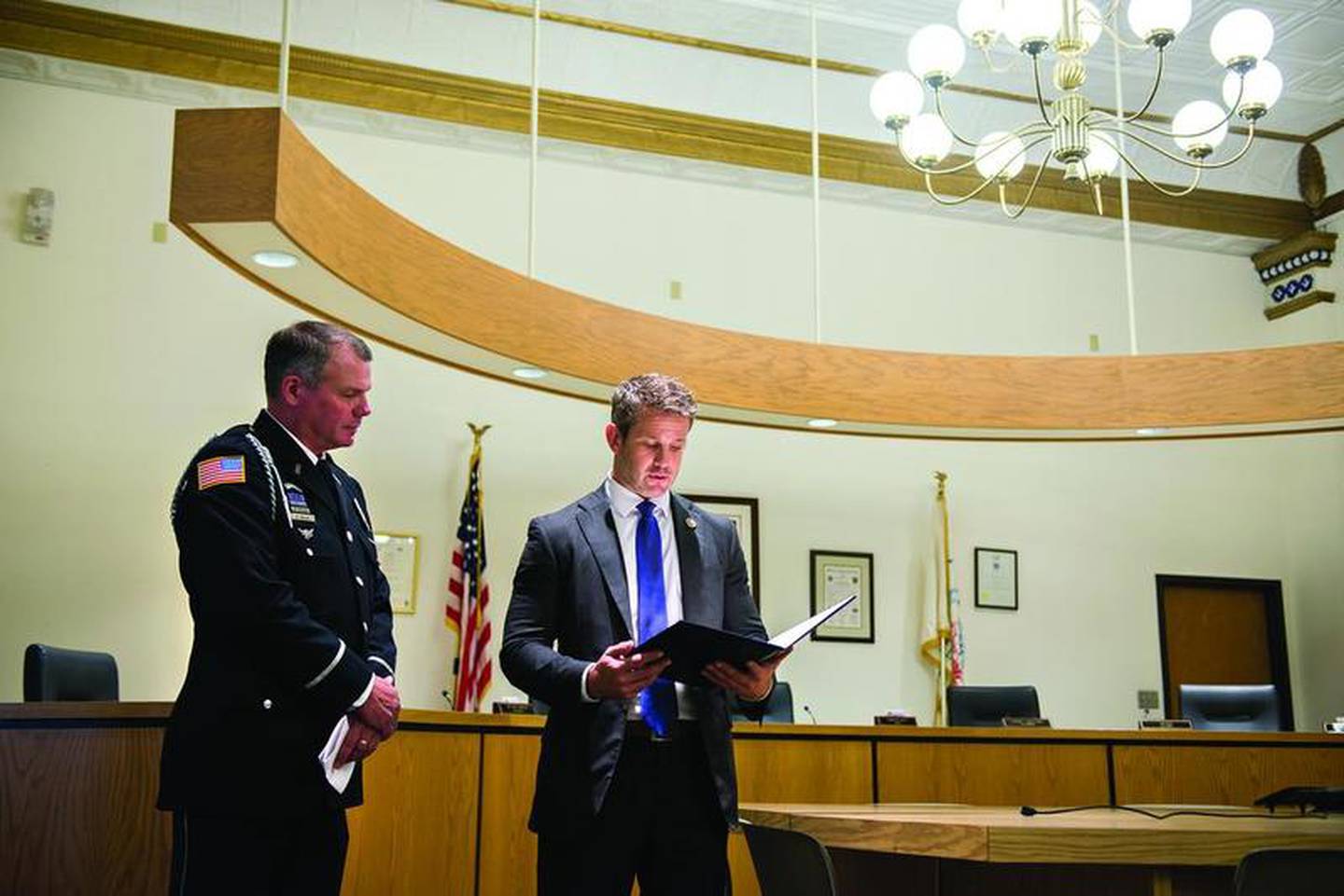 U.S. Rep. Adam Kinzinger (right) reads the statement he made on the House floor honoring Dixon school resource officer Mark Dallas. Kinzinger was in Dixon on Wednesday, Aug. 8, 2018, to honor Dallas for his actions during the May 16 school shooting at Dixon High School.