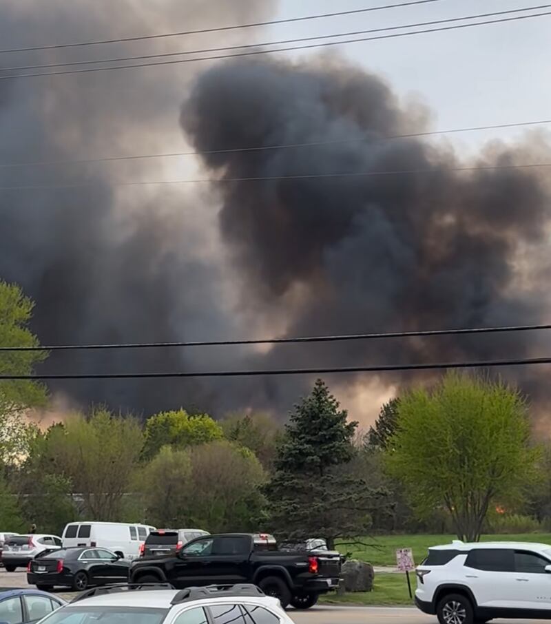 Black smoke fills the sky during a brush fire in Island Lake Sunday, May 4, 2025, that burned more than 100 acres, officials said.