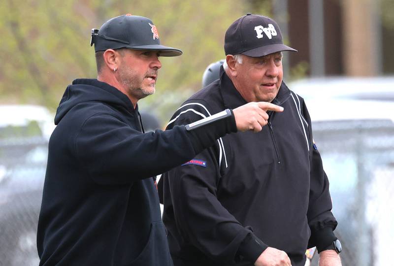 DeKalb head coach Josh Latimer talks to an umpire Tuesday, May 5, 2026, during their game against Neuqua Valley at DeKalb High School.