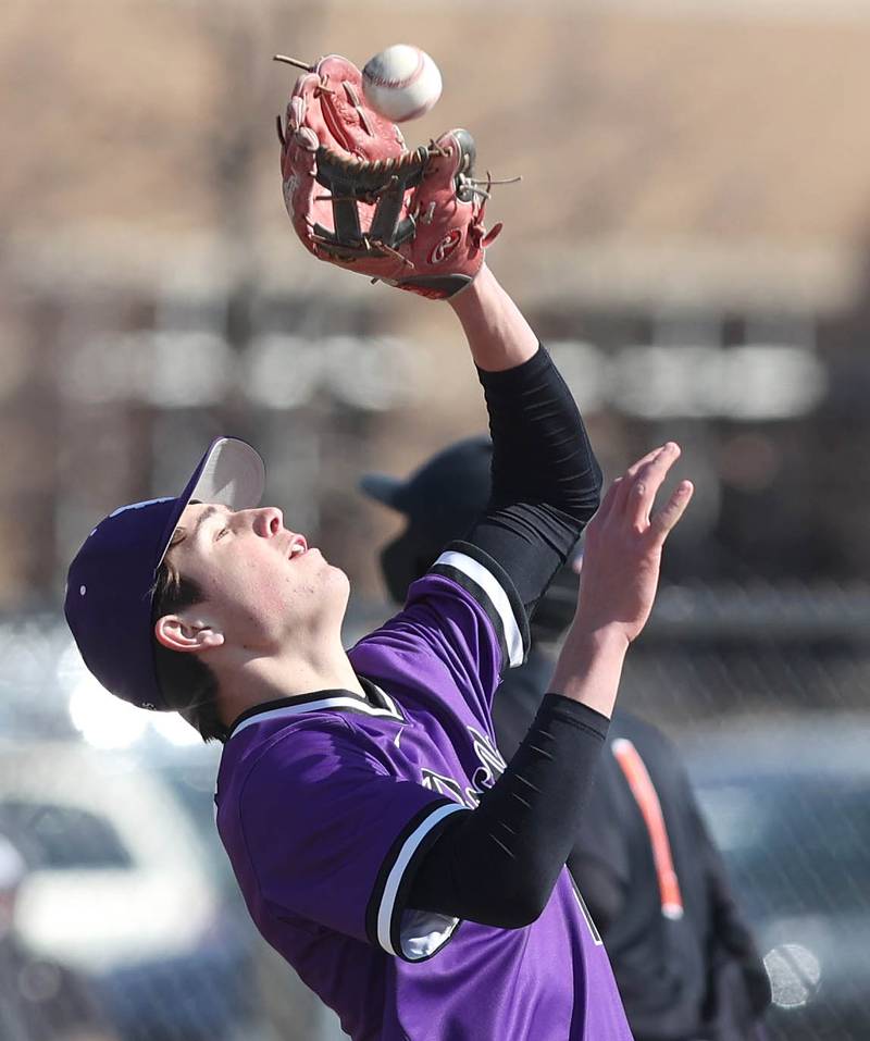 Dixon's Alex Harrison catches an infield popup during their game against DeKalb Tuesday, March 28, 2023, at DeKalb High School.