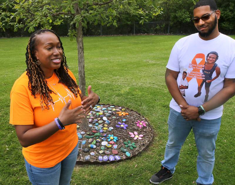 Andrea Harden, mother of Ezra Hill Jr. and Brandon Elion Ezra’s stepfather, talk about Ezra next to a tree and rock garden at Tyler Elementary School Monday, May 12, 2025, that is dedicated to the memory of Ezra, who was was murdered in 2019 in Harvey. An Ezra Hill Jr. Memorial Rock Painting event will be held on June 7 at the school in DeKalb.