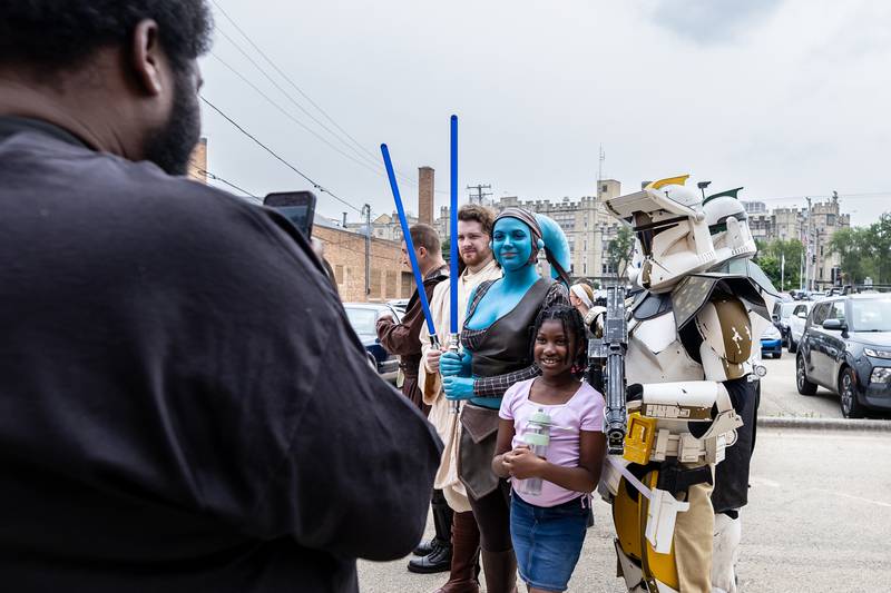Joliet resident Maurice Avent takes a photo of his daughter Jocelyn posing with Star Wars Day Parade participants during Joliet Public Library's event on June 7, 2025.