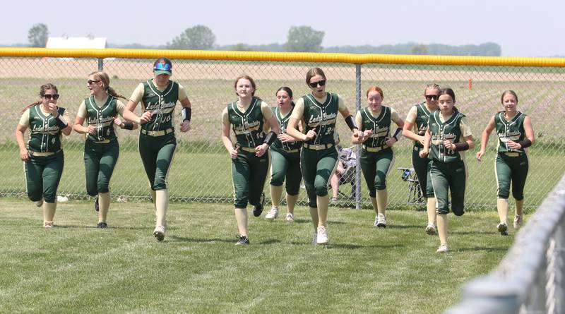 Members of the St. Bede softball team run to the outfield between innings in the Class 1A Regional final game on Saturday, May 20, 2023 in Annawan.