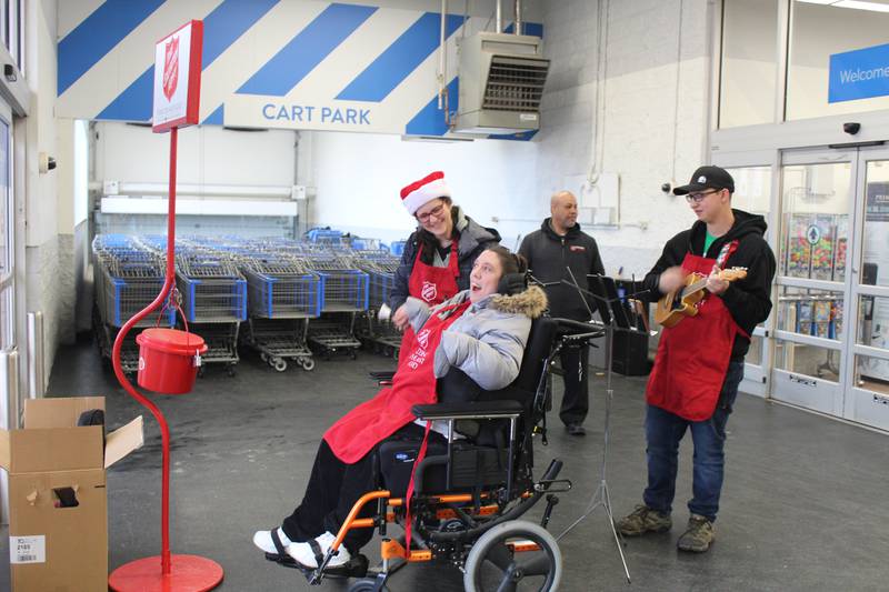 Tracy Schatteman, Amanda Nielsen and Sam Schatteman volunteer by ringing bells for Salvation Army donations at the Harvard Walmart Saturday, Dec. 16, 2023.