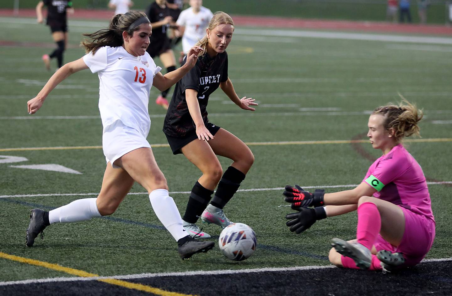 Crystal Lake Central's Jordin Gaunaurd (left) tries to take a shot on goal as Huntley's Ashlyn Grabs (right) goes to grab the ball as Huntley's Sophie Virgilio (center) tries to help get the ball out of the box during a Fox Valley Conference soccer match on Tuesday, April 14, 2026, at Huntley High School.