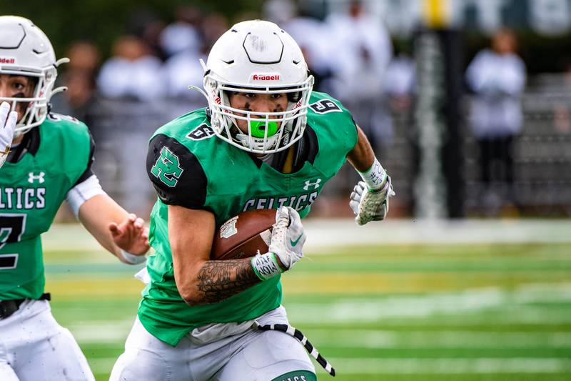 Providence's Mason Santiago runs the ball during a 2022 second-round playoff game against Joliet Catholic in New Lenox.