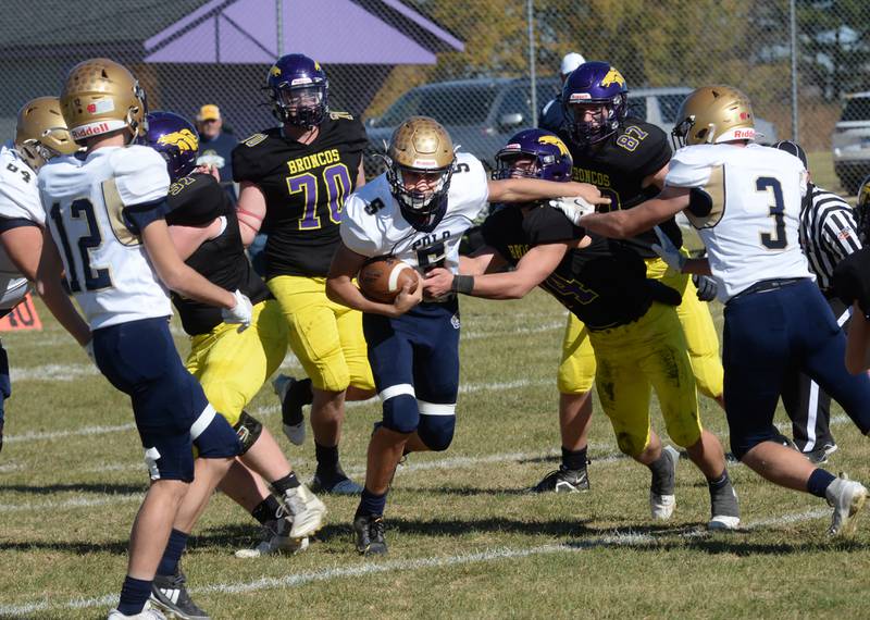 Polo's Gus Mumford (5) cuts through Orangeville defenders for a big gain during Saturday, Oct. 26, 2024 action at Orangeville. The Marcos finished the regular season in 8-man football undefeated with an 8-0 record. The state playoffs begin this week.