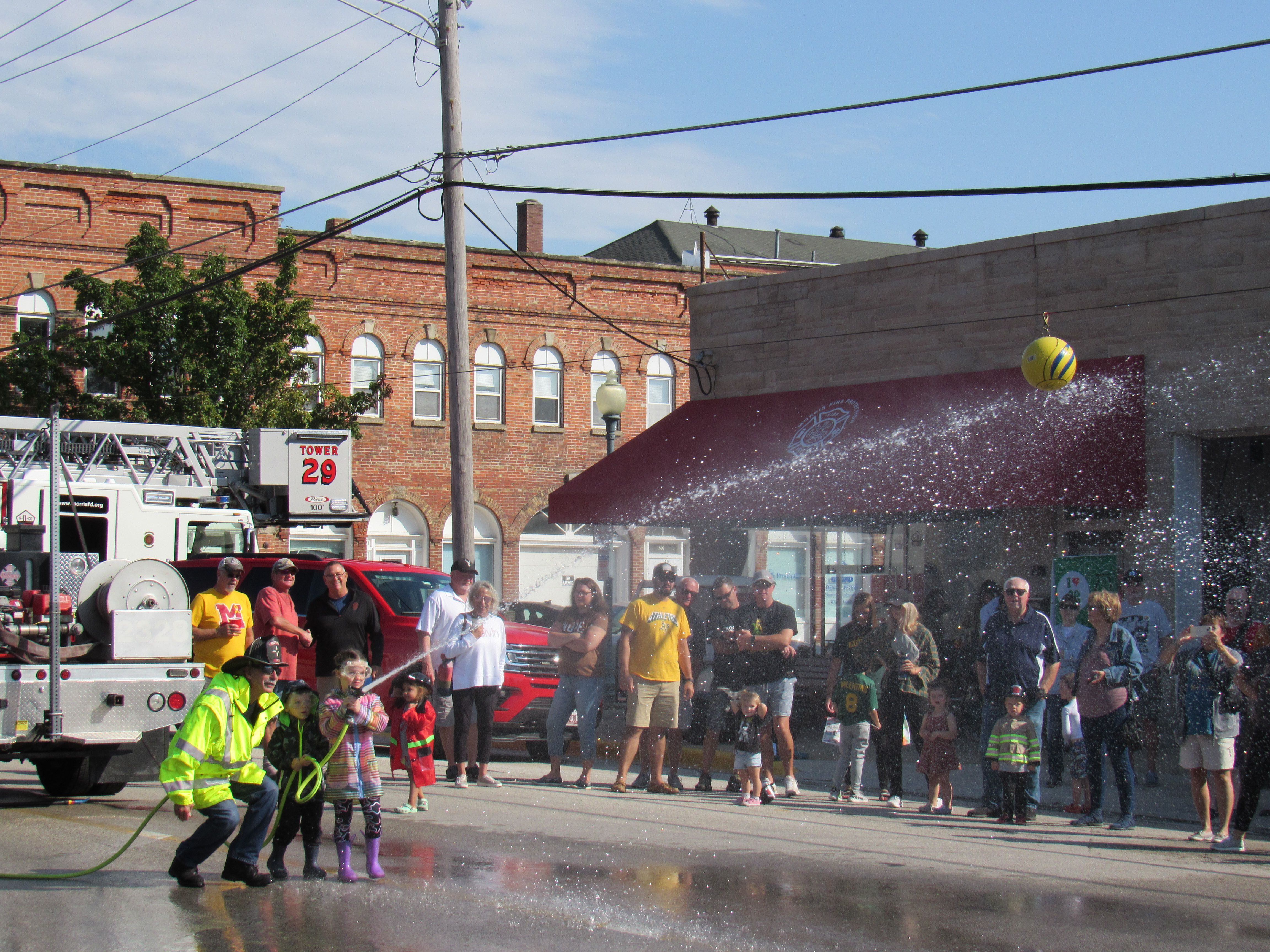 Bennett and Sadie compete in the kiddie water fights at the Grundy County Corn Festival.