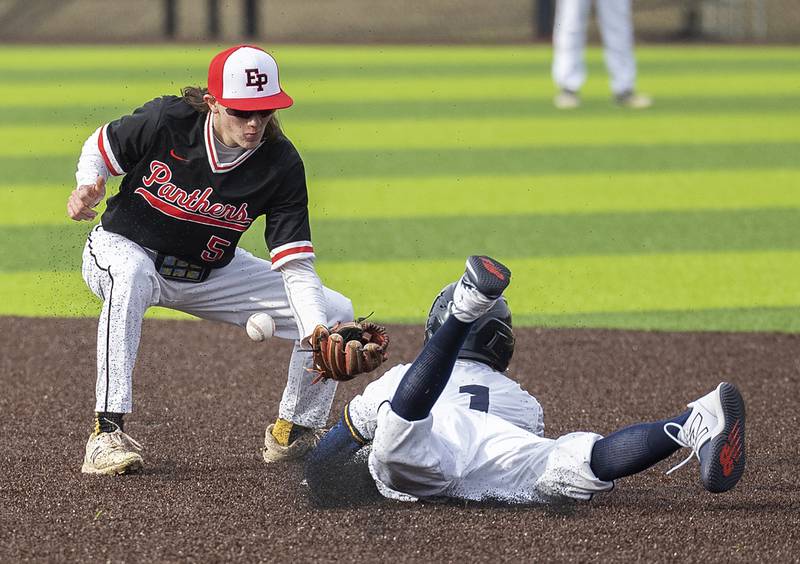 Sterling’s Ayden Schoon slides in safely to steal second base after E-P’s Reece Duncan is unable to scoop a throw from the Panther’s catcher Wednesday, March 15, 2023.