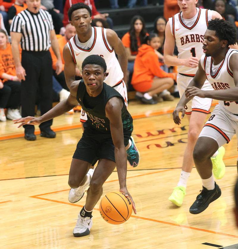 Waubonsie Valley's Tyreek Coleman avoids three DeKalb defenders on his way to the basket during their game Friday, Feb. 21, 2025, at DeKalb High School.