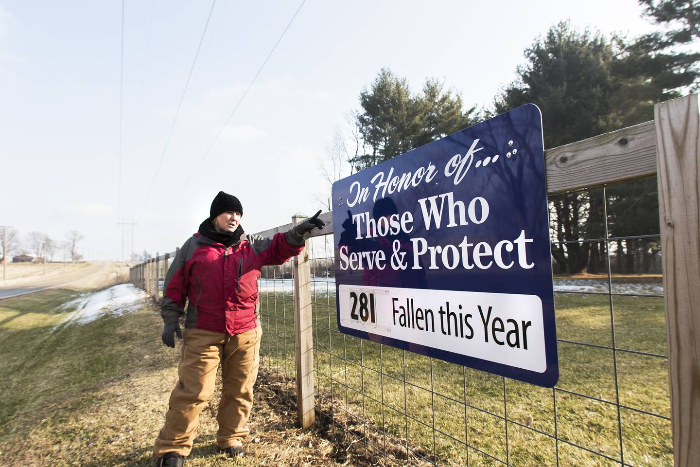 Karen Davis discusses her plans for a tribute to fallen officers at her property along Flagg Road in rural Oregon. Davis has a sign with updated numbers of fallen officers and on New Year's Eve a glow stick will be lit and attached to the fence in honor of each fallen officer. The display will last for about two nights or until the glow sticks stop glowing.