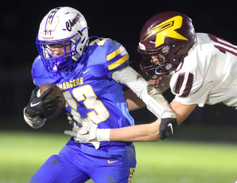 Aurora Central Catholic’s Aidan Crisci eludes Richmond-Burton’s Luke Robinson  in IHSA football Class 3A second-round playoff action at Bob Stewart Field on the campus of Aurora Central Catholic High School in Aurora on Friday, November 7, 2025.