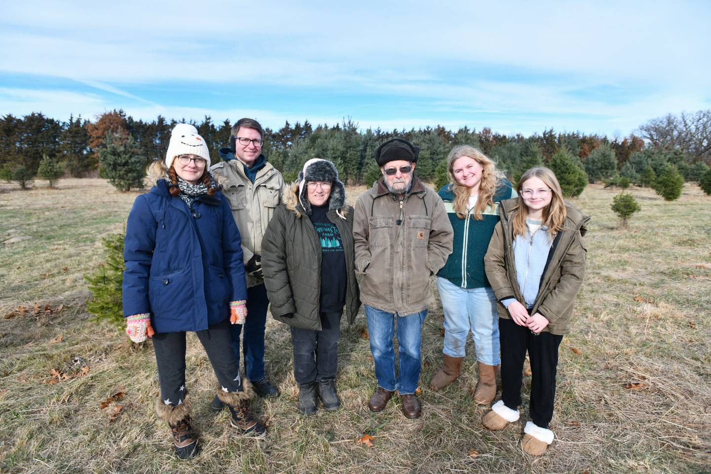 Bruce and Becky Tammen (center), owners of Tammen Treeberry Farm in Wilmington, stand with their daughter, Sarah, left, and her husband Chris Gruber and their children, Alice, 17, and Lucy, 13, (at right), on Nov, 30, 2024.