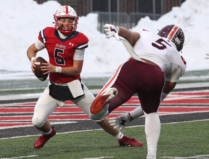 St. Rita's Steven Armbruster puts a move on Brother Rice's Kameron McGee Wednesday, Dec. 3, 2025, during their IHSA Class 7A state chamionship game in Huskie Stadium at Northern Illinois University in DeKalb.