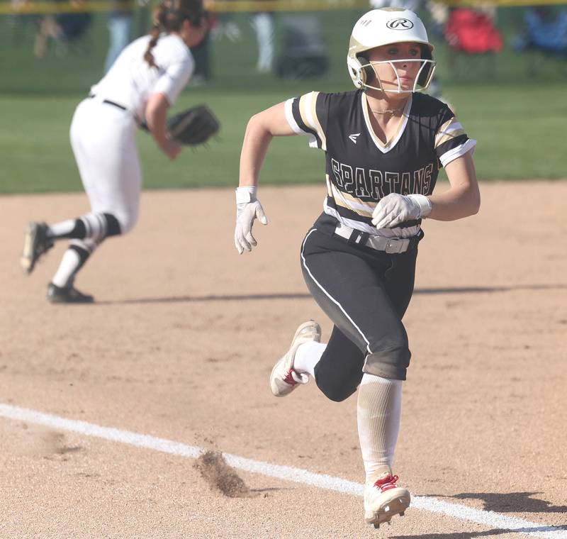 Sycamore's Addison McLaughlin comes home with the games first run Friday, April 28, 2023, during their game against Kaneland at Sycamore High School.