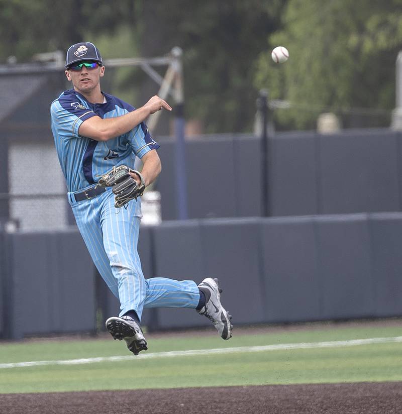 Ottawa Marquette’s Grady Dose makes a jumping throw for an out at first against Father McGivney Saturday, June 7, 2025, during the Class 1A state baseball final at Illinois Field in Champaign.
