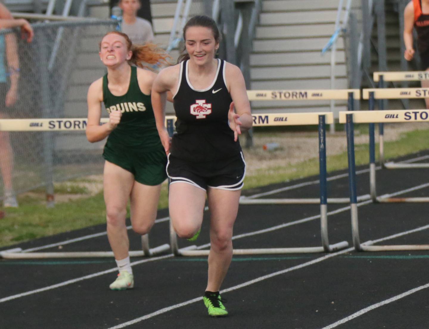 Indian Creek's Kaitlyn Frazier sprints past St. Bede's Macy Zeglis to take second place in the 100-meter hurdles Wednesday, May 11, 2022, at Bureau Valley High School in Manlius.