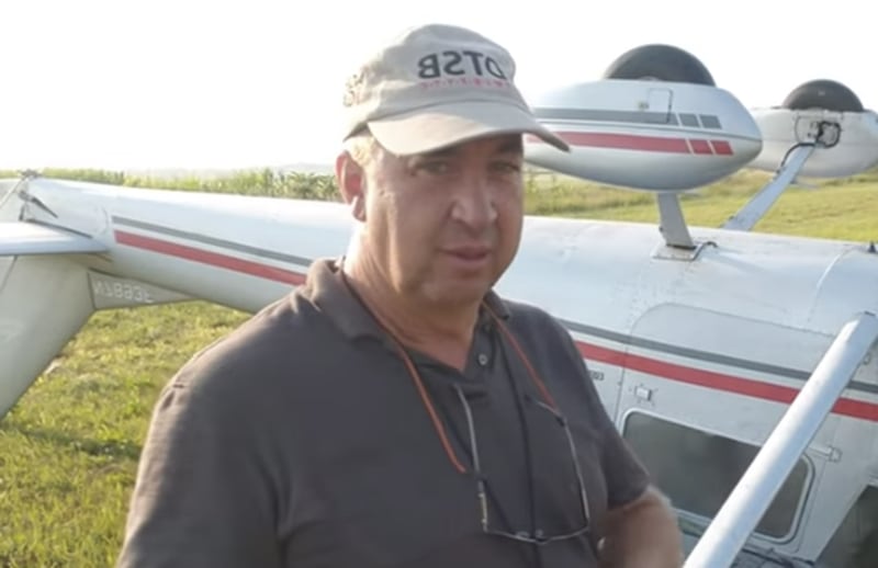 Pilot Dan Gryder stands in front of the inverted Cessna 150 he was attempting to fly when he was forced to crash in a nearby corn field in rural Rock Falls July 24.