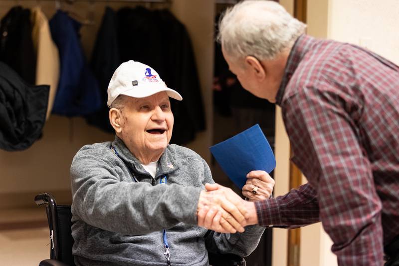 Veteran Sherman “Spud” Vaughn receives birthday greetings from Oak Forest resident John Lavezzi during his 100th birthday celebration at First Presbyterian Church on March 9, 2024.