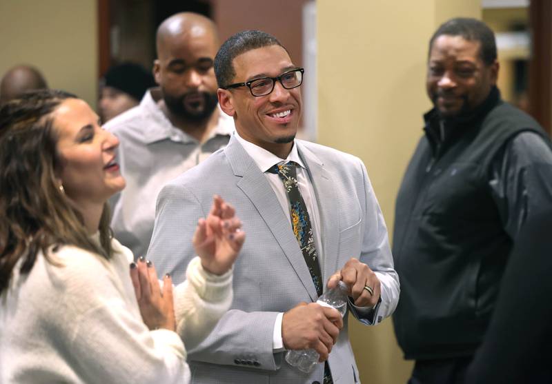 John Walker, (center) current DeKalb 7th Ward Alderman and candidate for mayor, talks to attendees Wednesday, Feb. 19, 2025, at the DeKalb Area Rental Association and DeKalb Area Builders Association Candidate Night at Faranda's Banquet Center in DeKalb.