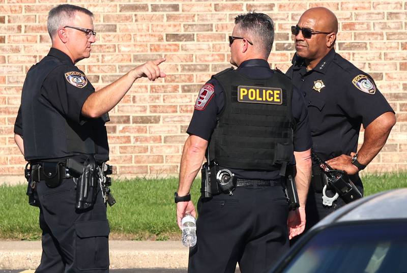 DeKalb Police Chief David Byrd (right) talks to DeKalb and Northern Illinois University police at the scene of a shooting Wednesday, Aug. 24, 2022, at West Ridge Apartments in DeKalb.