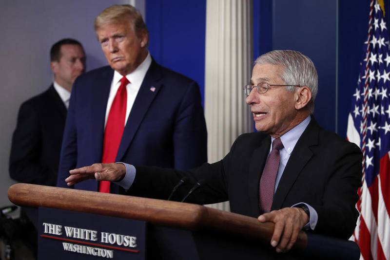 FILE - In this April 22, 2020, file photo, President Donald Trump listens as Dr. Anthony Fauci, director of the National Institute of Allergy and Infectious Diseases, speaks about the coronavirus in the James Brady Press Briefing Room of the White House in Washington. (AP Photo/Alex Brandon, File)