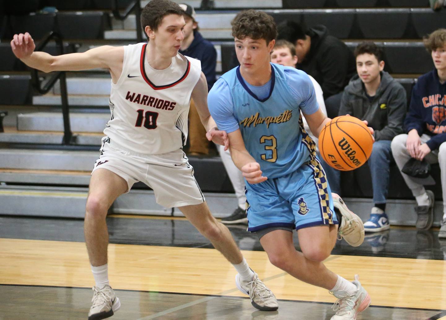 Marquette's Easton Debernardi dribbles around Woodland's Jaron Follmer during the Tri-County Conference Tournament on Tuesday, Jan. 28. 2025 at Putnam County High School.